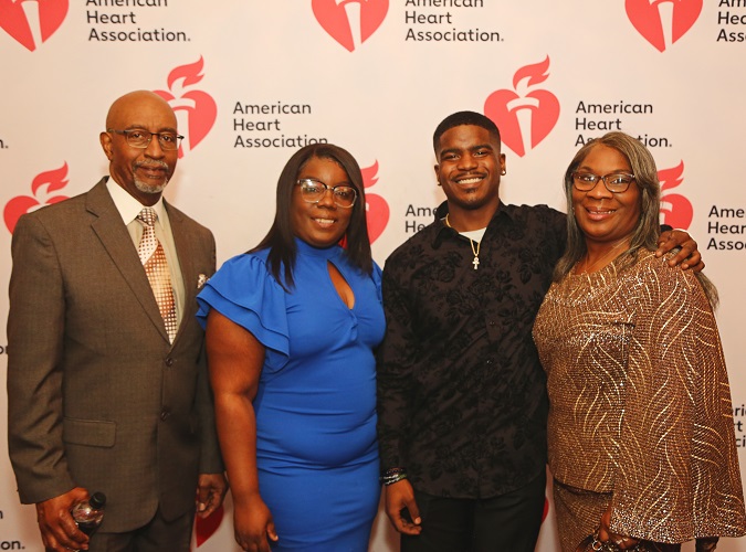 Four people in front of American Heart Association banner